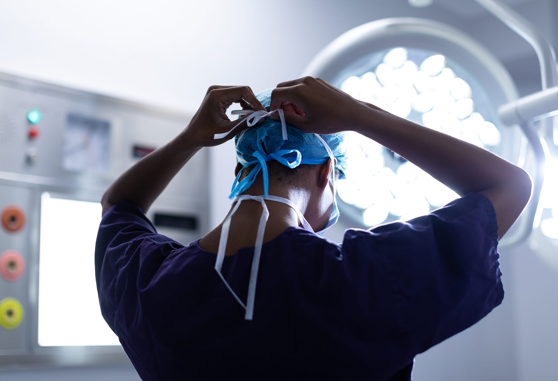 Doctor putting on his surgical mask